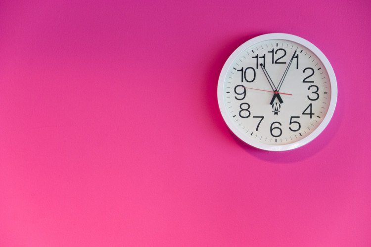 white clock on pink wall